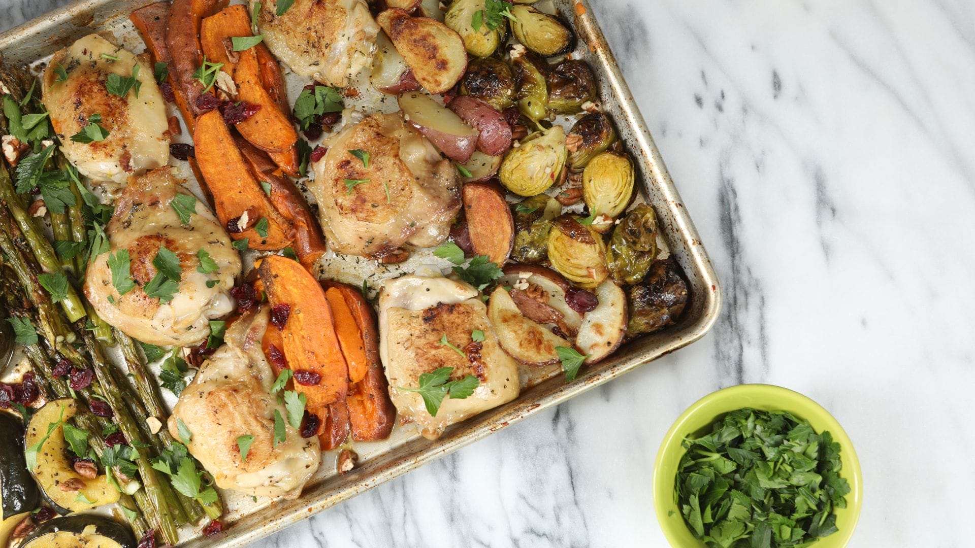 chicken thighs and vegetables on a sheet pan