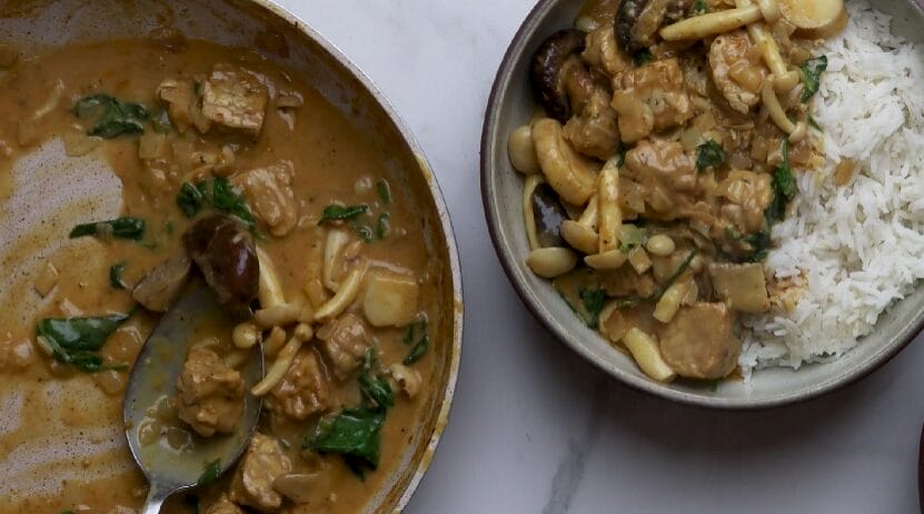 vegan curry in a bowl with jasmine rice and in a pan