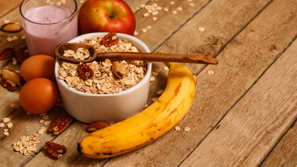 a bowl of oatmeal with a spoon and fruit