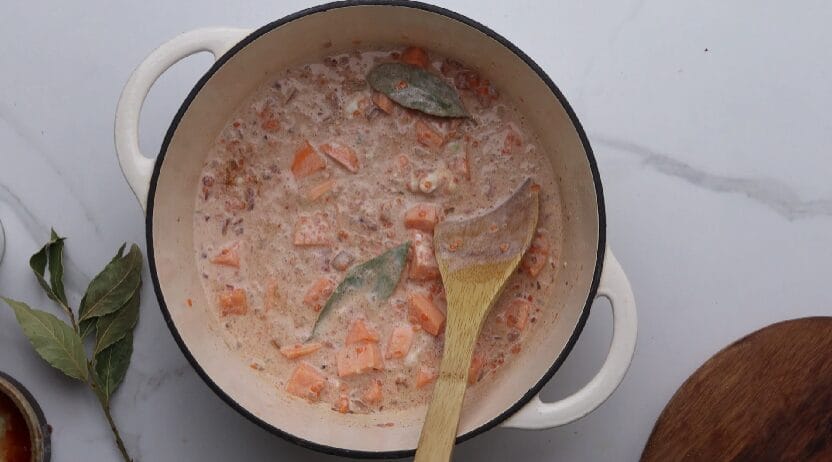 combining ingredients for dahl in a pot